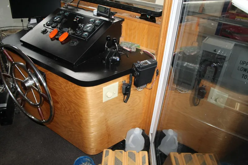 Slide: The Image of The image shows a boat's helm with a wood finish and various controls. - 33