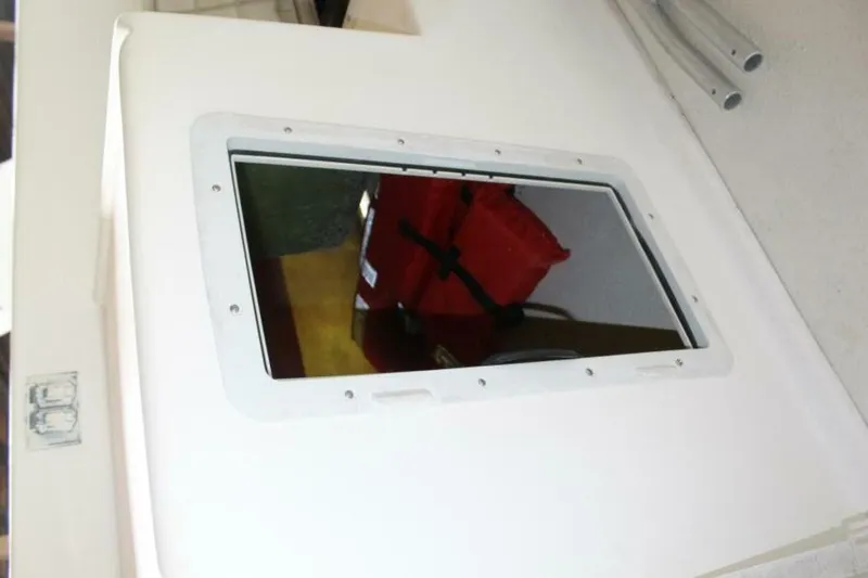 Slide: The Image of A window on a boat with a red life ring in the background. - 47