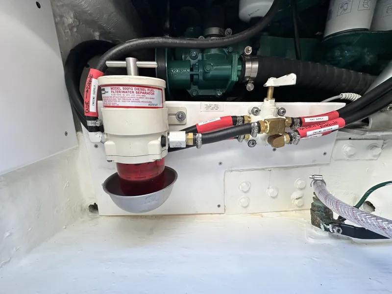 Slide: The Image of A fuel filter and hoses in the engine compartment of a 2006 Albin 26 Center Console boat. - 15