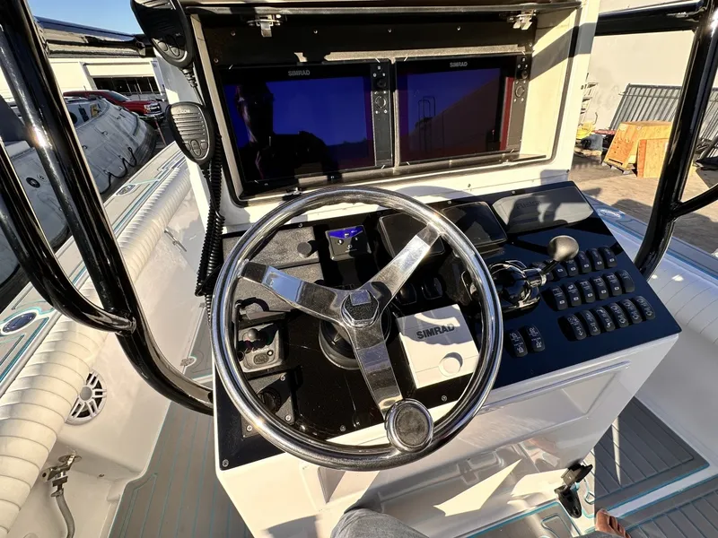 Slide: The Image of The image shows the helm of a 2006 Albin 26 Center Console boat with modern instruments. - 12