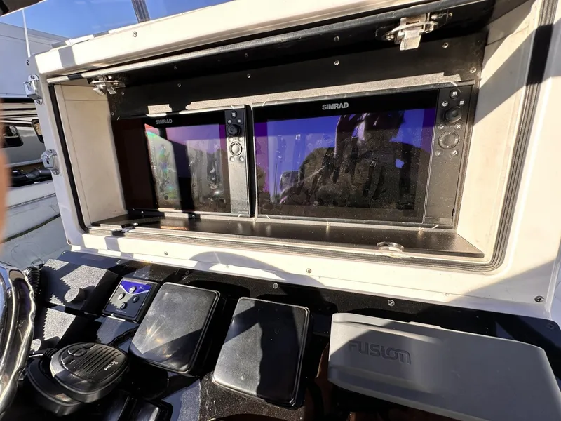 Slide: The Image of The image shows the dashboard of a 2006 Albin 26 Center Console boat with Simrad screens. - 9