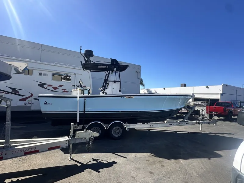 Slide: The Image of 2006 Albin 26 Center Console on a trailer, parked outdoors in sunny weather. - 18