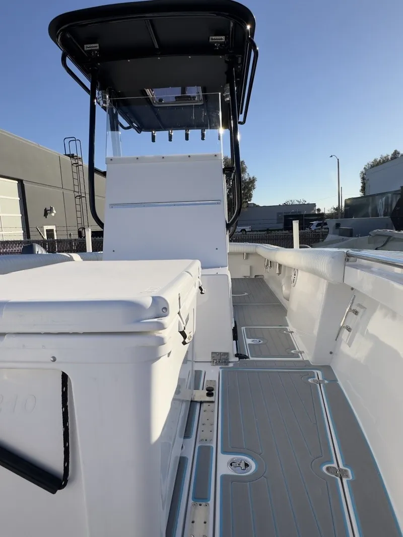 Slide: The Image of A 2006 Albin 26 Center Console boat with a white deck and black T-top. - 4