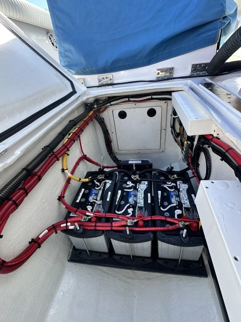 Slide: The Image of The 2006 Albin 26 Center Console features a well-organized battery compartment with multiple batteries and wiring. - 17