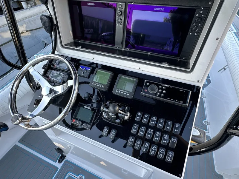 Slide: The Image of The image shows the helm of a 2006 Albin 26 Center Console boat with modern instruments. - 16