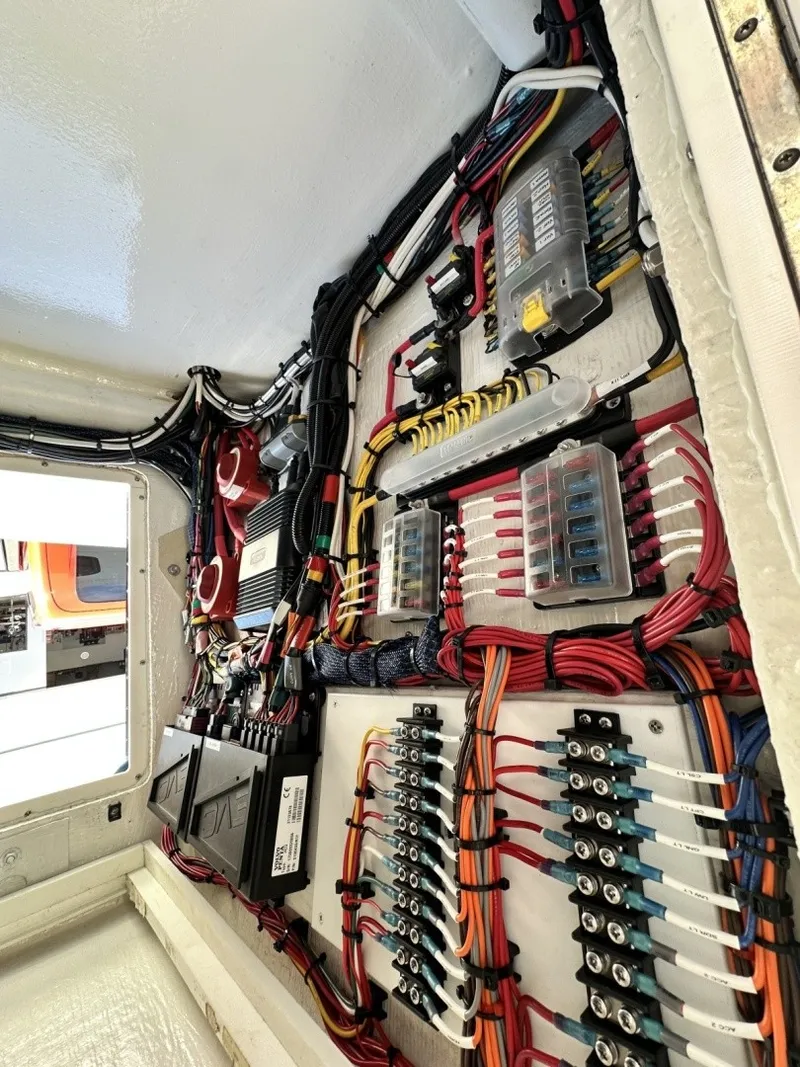 Slide: The Image of Electrical panel with colored wires and fuses inside a boat. - 14