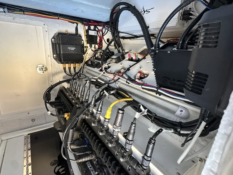 Slide: The Image of The engine compartment of a 2006 Albin 26 Center Console shows complex wiring and electronics. - 6