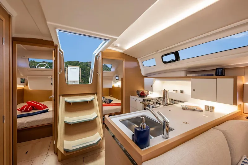 Slide: The Image of Manufacturer Provided Image: Luxurious interior of 2025 Jeanneau Sun Odyssey 415 yacht with modern kitchen and cozy cabins. - 2