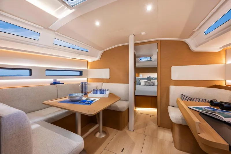 Slide: The Image of Manufacturer Provided Image: Luxurious interior of 2025 Jeanneau Sun Odyssey 415 yacht with modern dining area. - 1