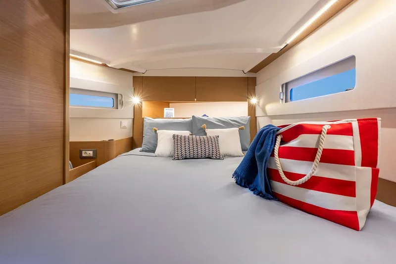 Slide: The Image of Manufacturer Provided Image: Luxurious cabin interior of 2025 Jeanneau Sun Odyssey 415 yacht with cozy bedding. - 5