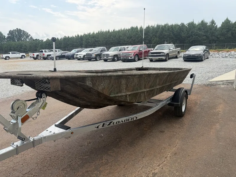 Slide: The Image of A G3 Gator Tough 15DK-25HP boat on a trailer, surrounded by cars and trees. - 6