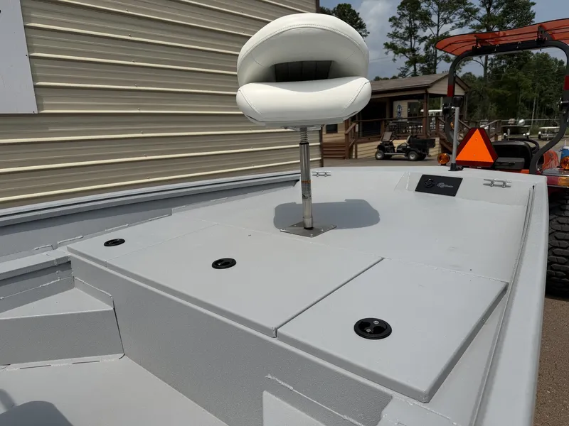 Slide: The Image of A white boat seat on a gray deck, surrounded by buildings and trees in the background. - 4