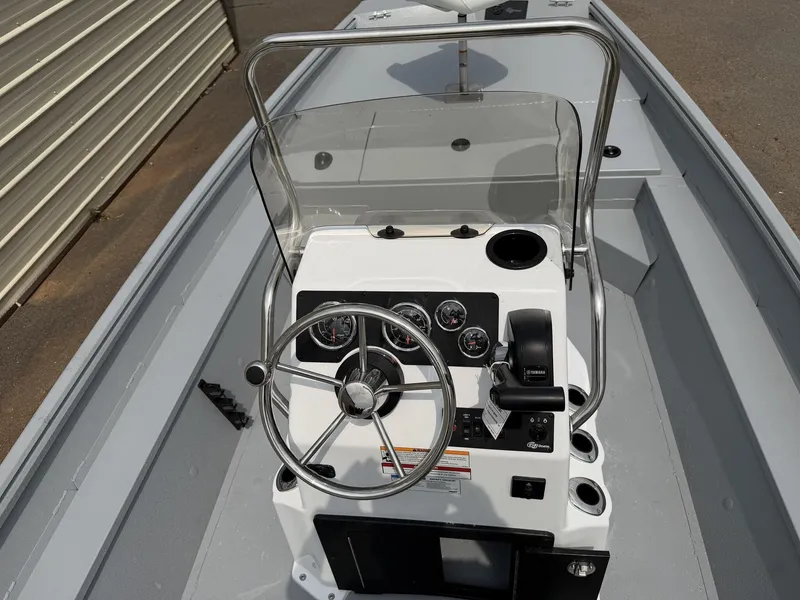 Slide: The Image of The image shows the helm of a 2027 G3 Bay 17 BAY-F70 WHITE boat with steering wheel and instruments. - 5