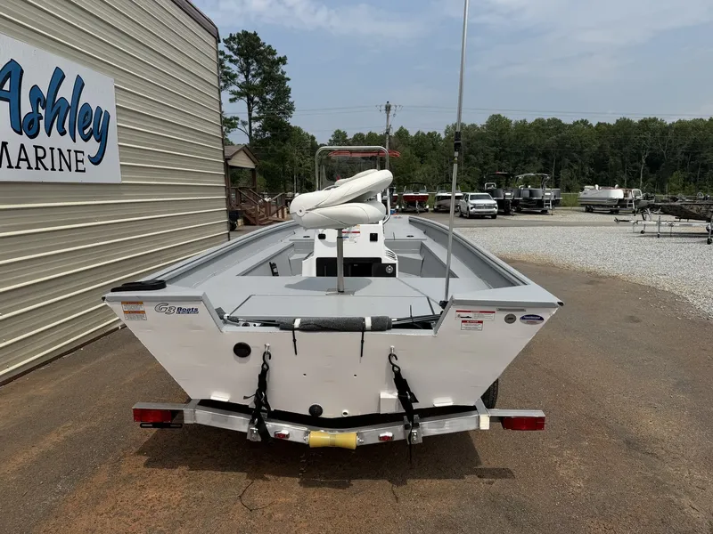 Slide: The Image of A white G3 Bay 17 boat on a trailer in front of a building labeled "Ashley Marine." - 6