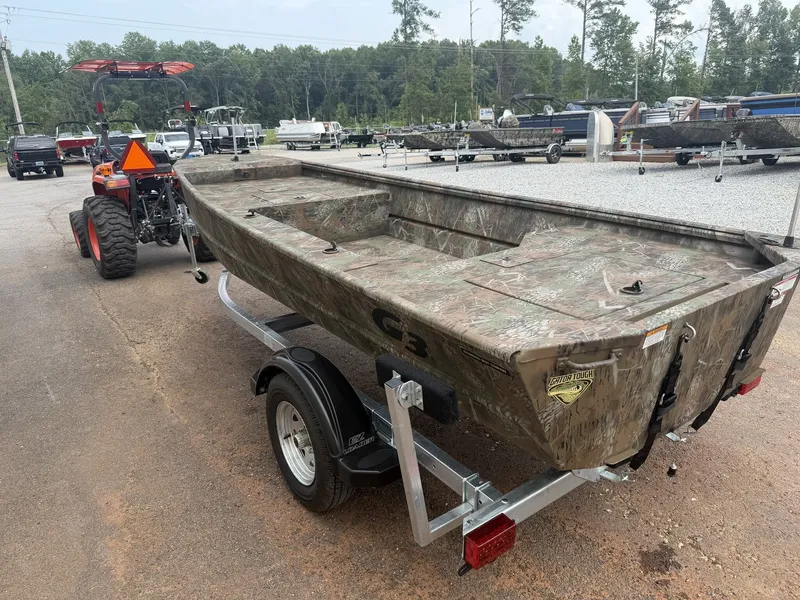 Slide: The Image of A G3 Gator Tough 15DK-25HP boat in camouflage color sits on a trailer. Trees and other boats are visible in the background. - 5