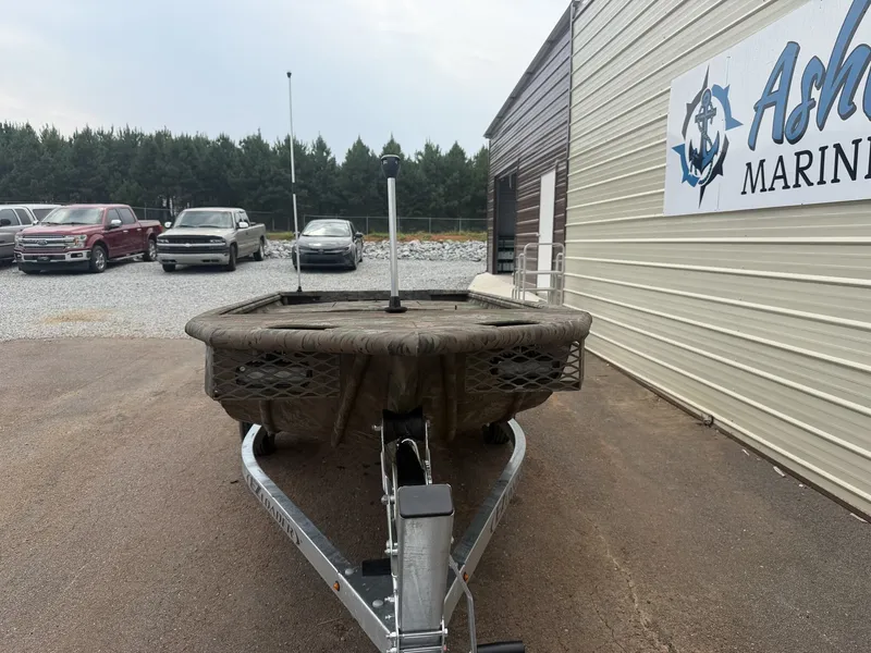 Slide: The Image of A G3 Gator Tough 15DK-25HP boat on a trailer in front of a building. - 2