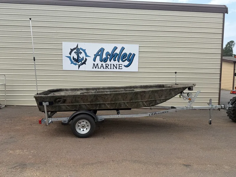 Slide: The Image of A G3 Gator Tough 15DK-25HP boat on a trailer in front of a building with "Ashley Marine" sign. - 1