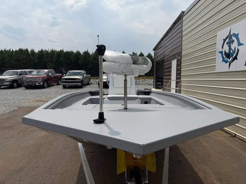 Slide: The Image of A 2027 G3 Bay 17 BAY-F70 WHITE boat on a trailer beside a building. - 2