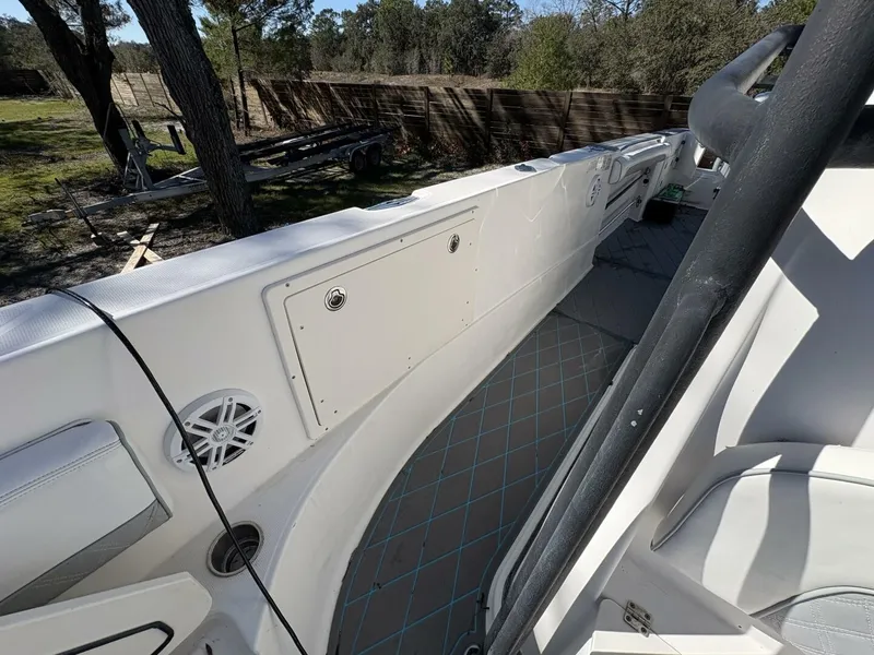 Slide: The Image of The image shows the deck of a 2008 Wellcraft 35 Scarab Sport. It features white upholstery and speakers. - 39