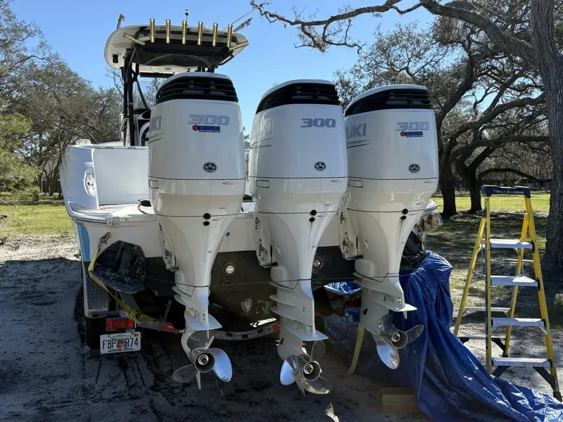 Slide: The Image of Rear view of a 2008 Wellcraft 35 Scarab Sport with three Suzuki 300 HP outboard engines. - 4