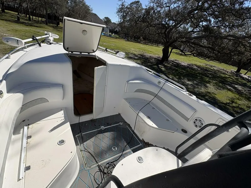 Slide: The Image of The image shows the cockpit of a 2008 Wellcraft 35 Scarab Sport. It features white seating and an open storage area. - 21