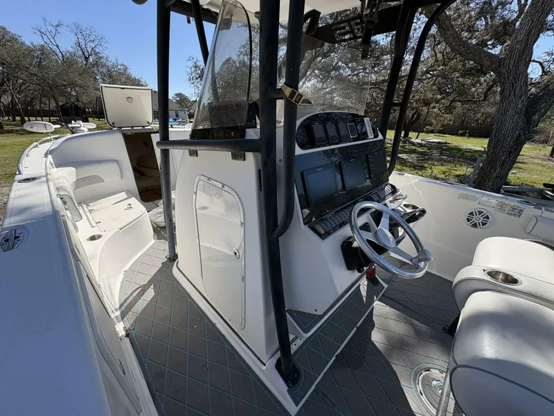 Slide: The Image of The image shows the cockpit of a 2008 Wellcraft 35 Scarab Sport boat with helm and seating. - 44