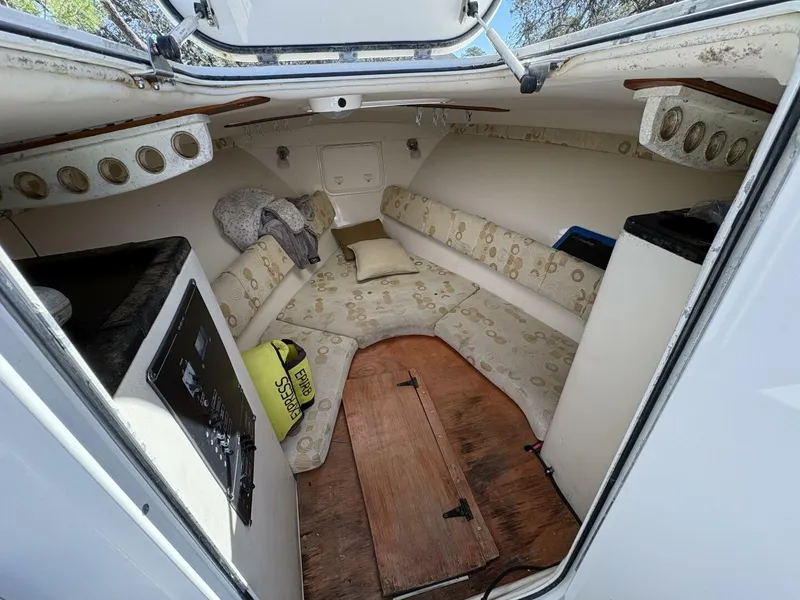 Slide: The Image of The image shows the interior of a 2008 Wellcraft 35 Scarab Sport. It features cushioned seating and wooden flooring. - 6