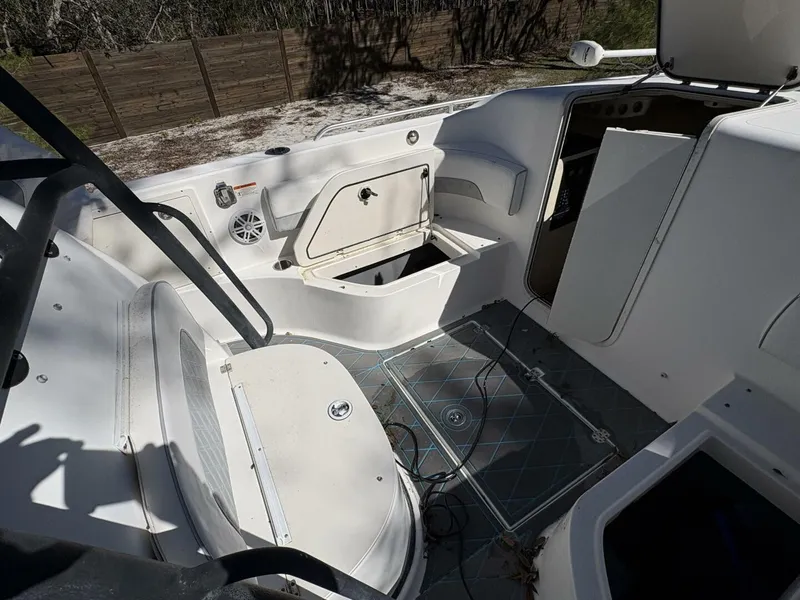 Slide: The Image of The image shows the cockpit of a 2008 Wellcraft 35 Scarab Sport. It features white upholstery and storage. - 23