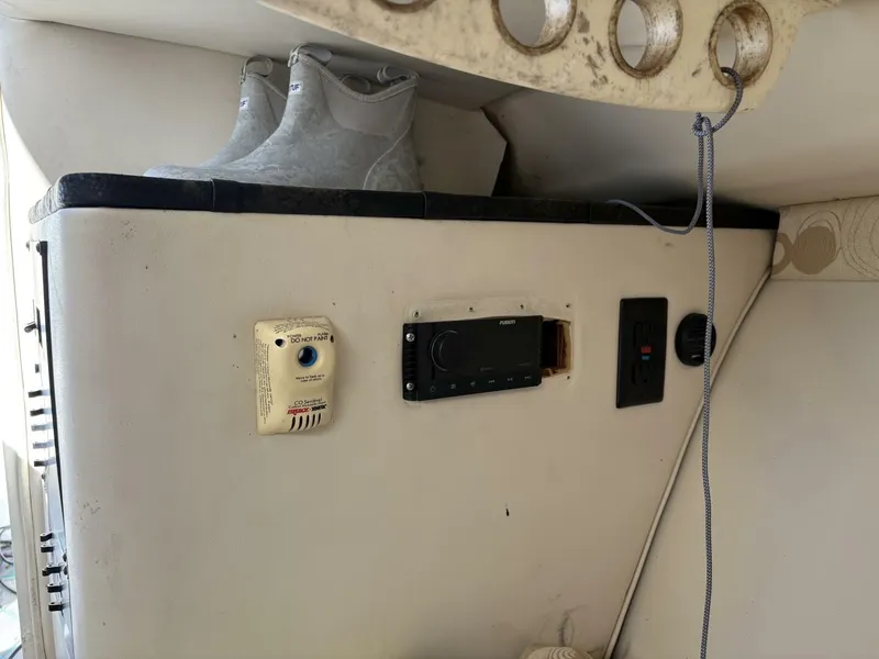 Slide: The Image of Interior of a 2008 Wellcraft 35 Scarab Sport with controls and boots on the shelf. - 32