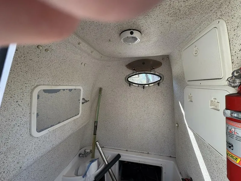 Slide: The Image of Interior of a 2008 Wellcraft 35 Scarab Sport with porthole, sink, and fire extinguisher. - 49