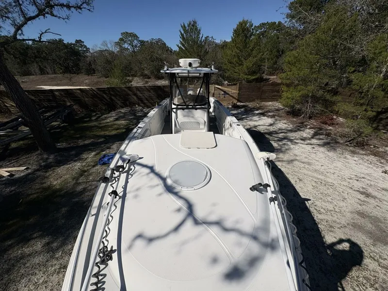 Slide: The Image of A 2008 Wellcraft 35 Scarab Sport is situated on dry, wooded terrain. - 13