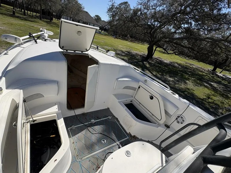 Slide: The Image of The image shows the cockpit of a 2008 Wellcraft 35 Scarab Sport boat with open storage compartments. - 11