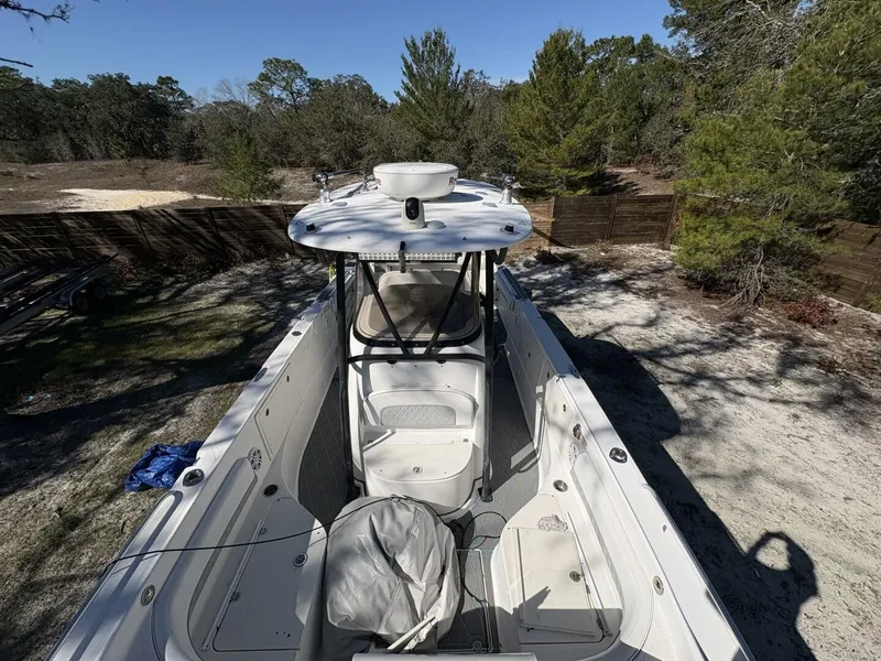 Slide: The Image of A 2008 Wellcraft 35 Scarab Sport boat is situated on a dry, wooded area. - 26