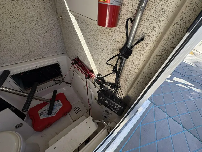 Slide: The Image of Interior view of a boat with a fire extinguisher, cables, and a red container. - 48