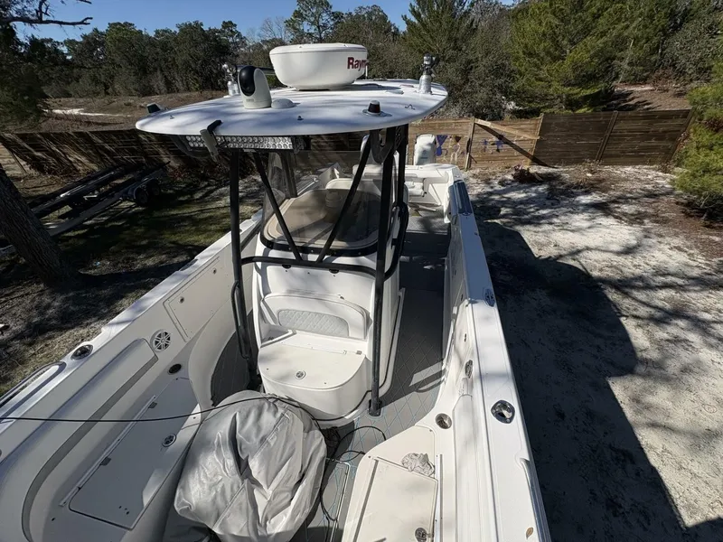 Slide: The Image of A 2008 Wellcraft 35 Scarab Sport with open deck, T-top, and radar on a wooded property. - 14