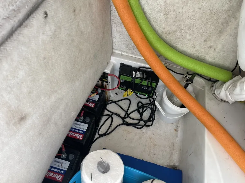Slide: The Image of A boat storage compartment with batteries, cables, and pool noodles. There's also a roll of paper. - 20