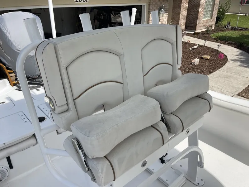 Slide: The Image of The image shows two cushioned seats on a boat, surrounded by a white structure. - 25
