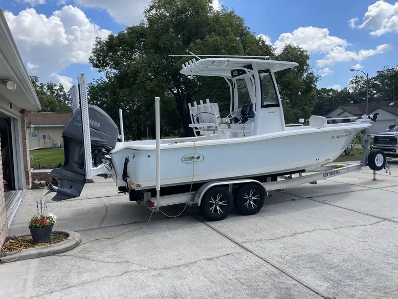 Slide: The Image of A 2020 Sea Hunt BX 25 FS boat on a trailer in a driveway. - 1
