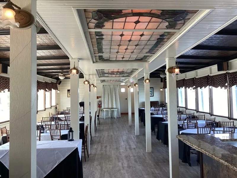 Slide: The Image of Interior of an elegant boat with wooden floors, decorative ceilings, and set tables. - 25