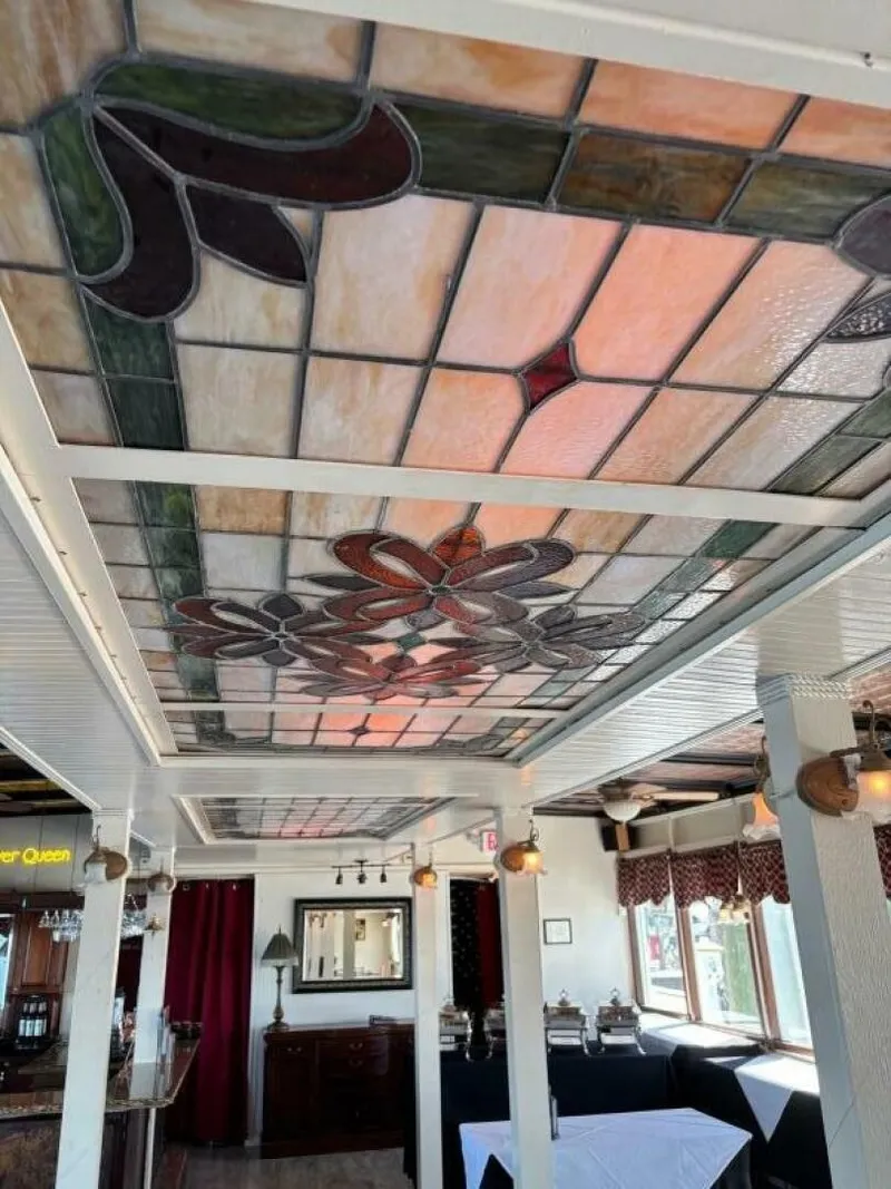 Slide: The Image of The image shows an elegant interior with an ornate stained glass ceiling. - 26