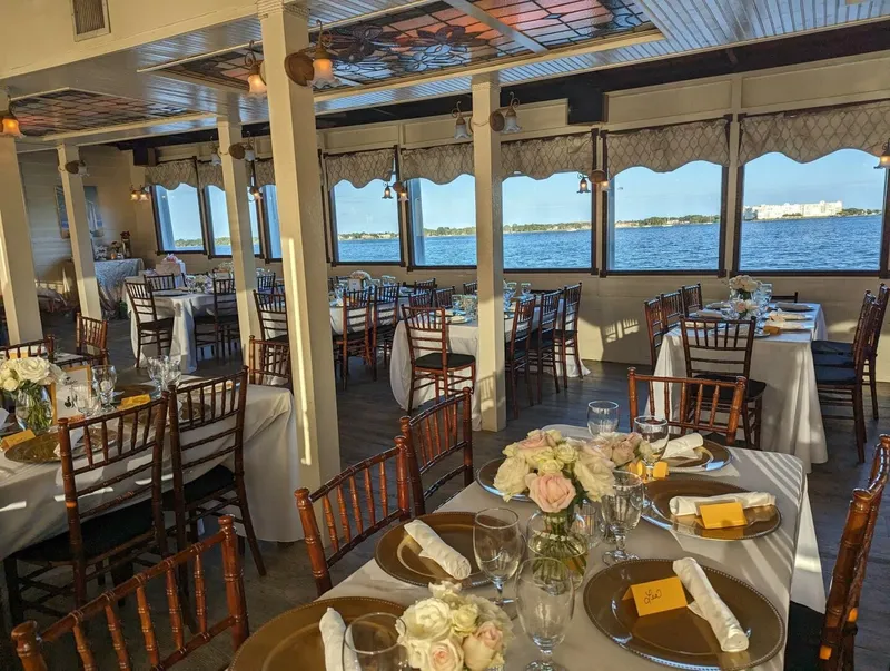 Slide: The Image of Elegant boat interior with set tables and a view of the water through large windows. - 17