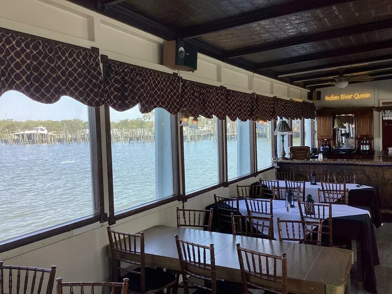 Slide: The Image of Interior of a boat with set tables and a view of the water through large windows. - 34
