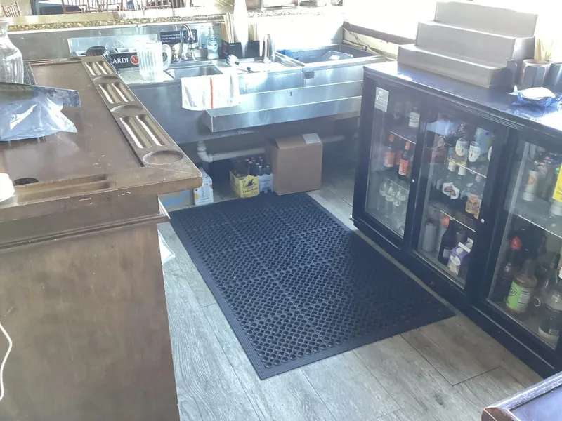 Slide: The Image of A bar with a beverage fridge, sink, and counter on a boat. - 31