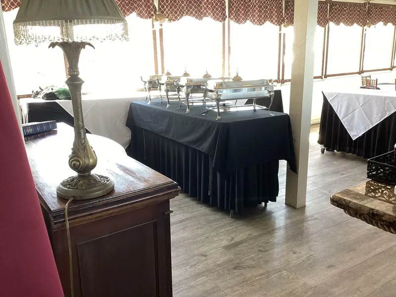 Slide: The Image of An elegant interior with set tables and an antique lamp. - 19