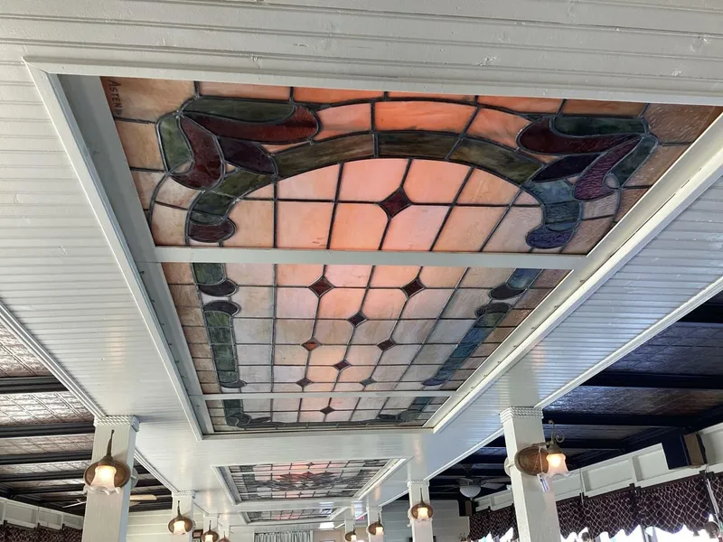 Slide: The Image of A decorative stained glass window with colorful patterns is set into the ceiling of a boat. - 23