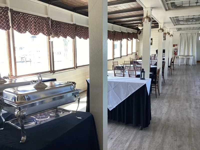 Slide: The Image of Interior of a 1984 paddle wheel boat with set tables and a buffet area. - 33