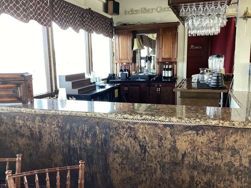 Slide: The Image of Interior of a boat cabin featuring an elegant bar, wooden furniture, and decorative curtains. - 28