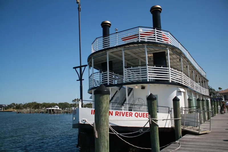 Slide: The Image of A two-story paddle wheel boat named "Indian River Queen" docked at a wooden pier. - 8