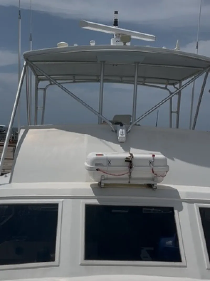 Slide: The Image of A 1987 Miller Sportfish 55 with a sturdy structure and a liferaft mounted at the front. - 14