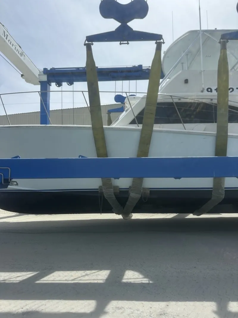 Slide: The Image of A 1987 Miller Sportfish 55 being lifted out of the water by a crane. - 11